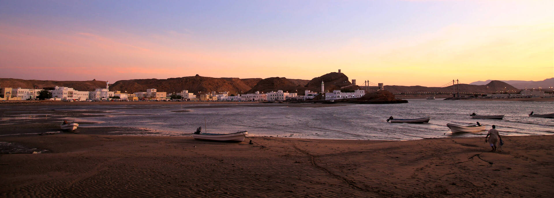 Fishing boats on the beach at sunset in Sur, Oman | nomad