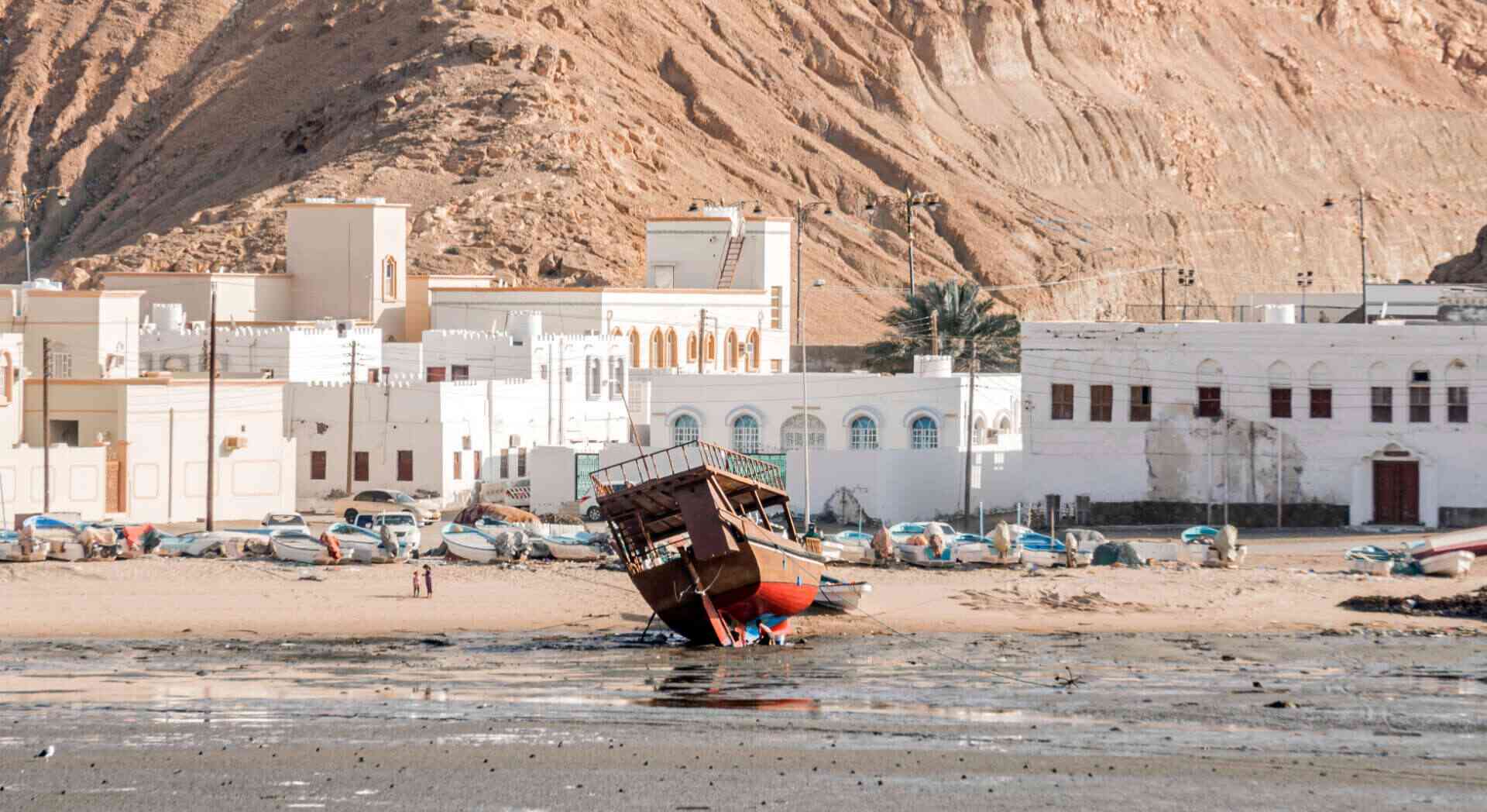Traditional wooden dhow boat on the beach in Sur, Oman | nomad